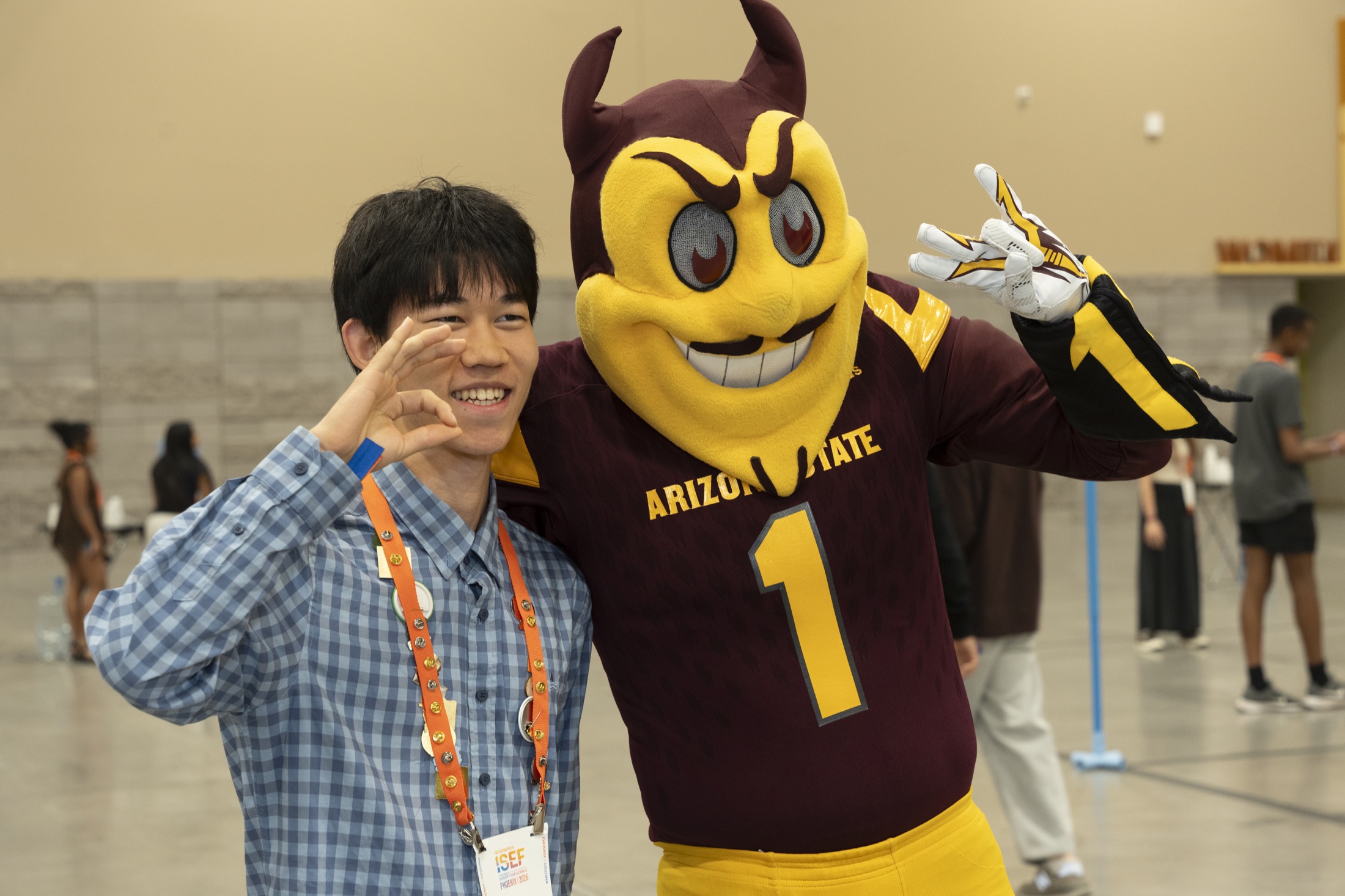Tenne with the Arizona State mascot at Regeneron ISEF